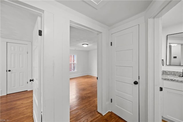 325 S Main St, Suffolk, VA 23434 - hall with light wood-style floors, baseboards, and a sink