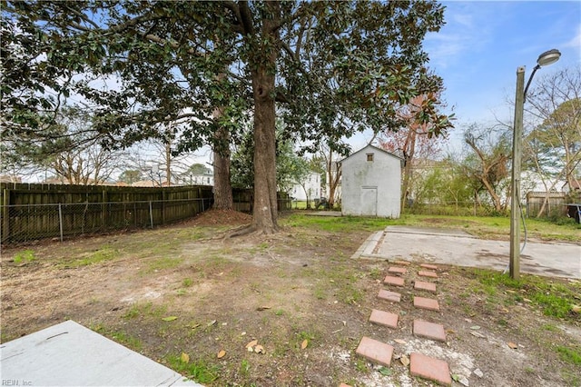 325 S Main St, Suffolk, VA 23434 - view of yard with an outbuilding, a fenced backyard, and a shed