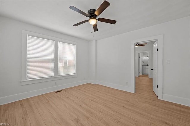 325 S Main St, Suffolk, VA 23434 - empty room featuring light wood-style floors, visible vents, baseboards, and a ceiling fan
