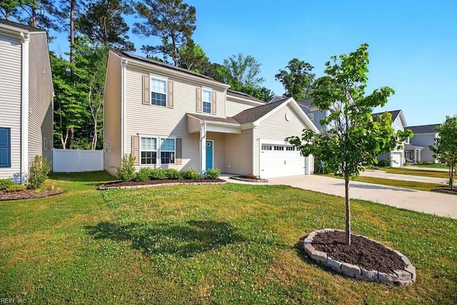 traditional-style house with concrete driveway, a garage, fence, and a front lawn