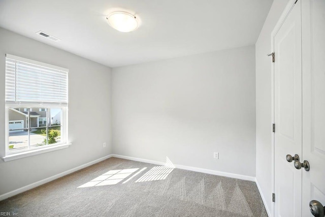 unfurnished bedroom with a closet, visible vents, baseboards, and carpet floors