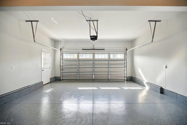 garage featuring baseboards and a garage door opener