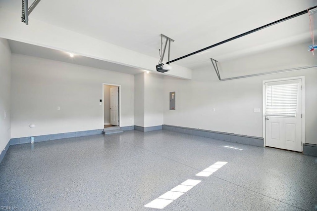 garage with electric panel, baseboards, and a garage door opener