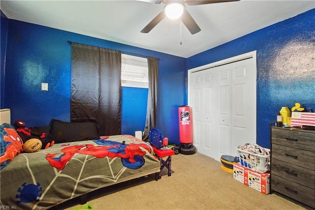 carpeted bedroom featuring a closet and a ceiling fan