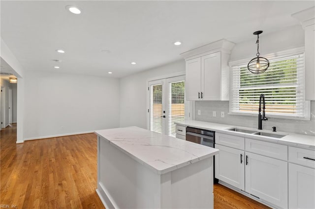 kitchen featuring a sink, dishwasher, a center island, recessed lighting, and decorative backsplash