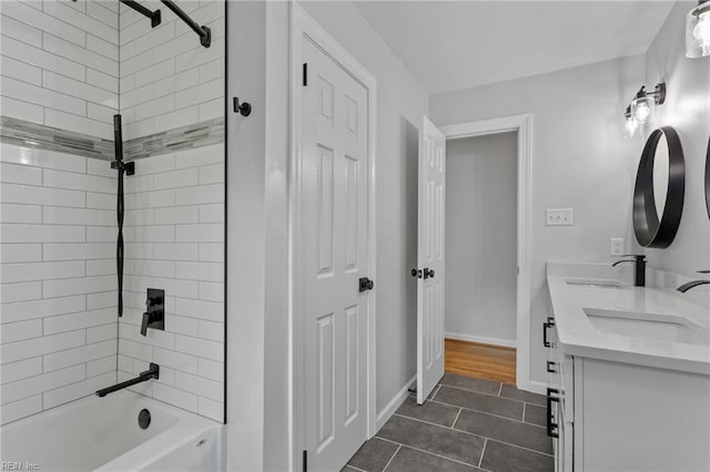 full bath featuring tile patterned flooring,  shower combination, double vanity, and baseboards