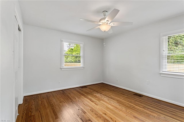 unfurnished room with baseboards, light wood-style flooring, and ceiling fan