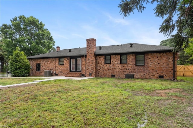 rear view of property featuring central air condition unit, a patio, crawl space, a chimney, and brick siding