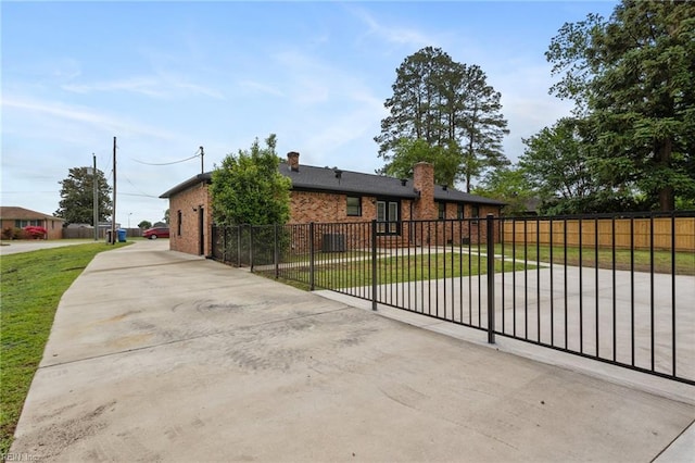 view of front facade with brick siding and concrete driveway
