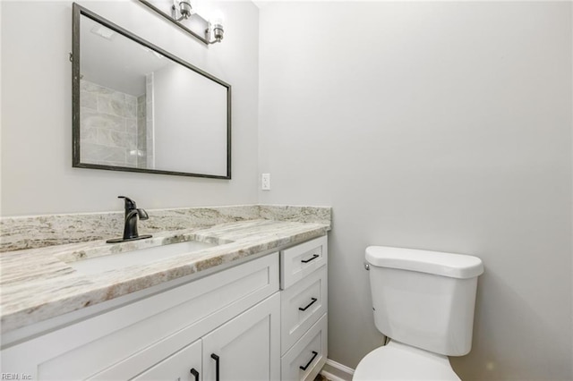bathroom with toilet and vanity