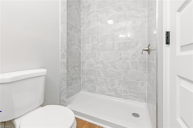 full bathroom with toilet and a shower stall