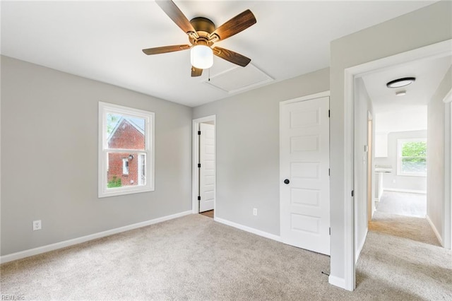 unfurnished bedroom with baseboards, multiple windows, and carpet floors