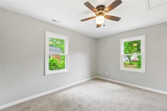spare room with visible vents, baseboards, and a healthy amount of sunlight