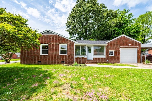 ranch-style home featuring an attached garage, brick siding, crawl space, and a front lawn