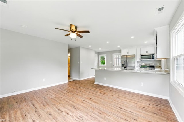 kitchen featuring recessed lighting, stainless steel appliances, and light wood-type flooring