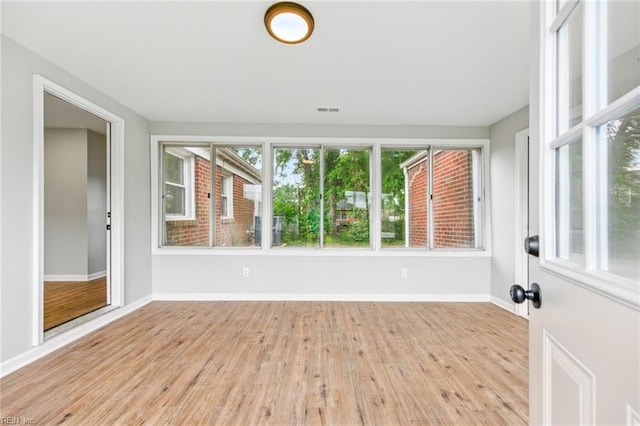 unfurnished sunroom with visible vents