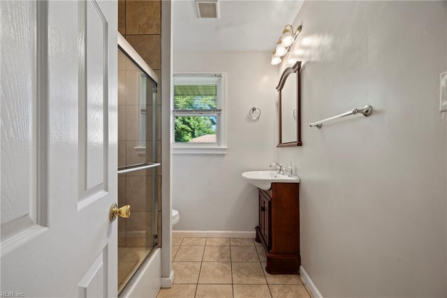 bathroom featuring toilet, vanity, visible vents, tile patterned floors, and baseboards