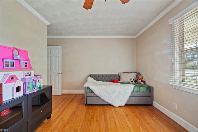 bedroom with light wood-style floors, baseboards, and a ceiling fan