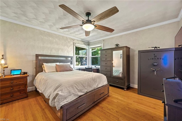 bedroom featuring light wood finished floors, crown molding, baseboards, and ceiling fan