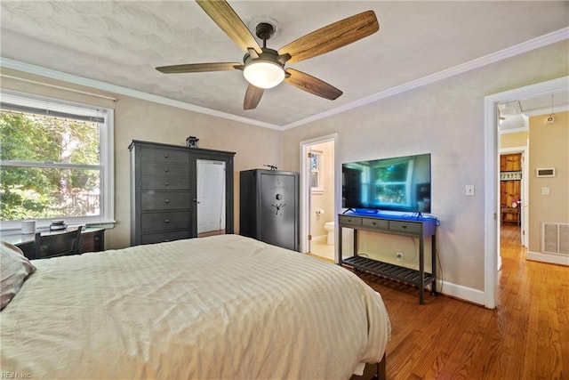bedroom featuring attic access, wood finished floors, baseboards, and ornamental molding