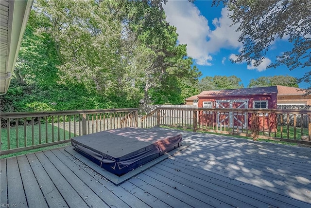 wooden deck with an outbuilding and a storage unit