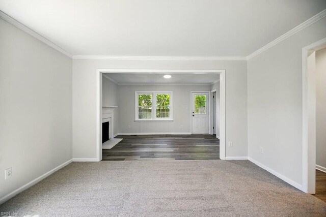 937 Sherry Cir, Newport News, VA 23608 - unfurnished living room featuring crown molding, dark colored carpet, and baseboards