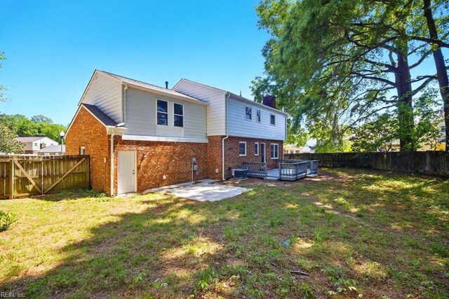 937 Sherry Cir, Newport News, VA 23608 - rear view of house featuring a fenced backyard, a patio area, a chimney, and brick siding