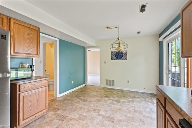120 Commodore Dr, Hampton, VA 23669 - unfurnished dining area with baseboards, stone finish floors, and a chandelier