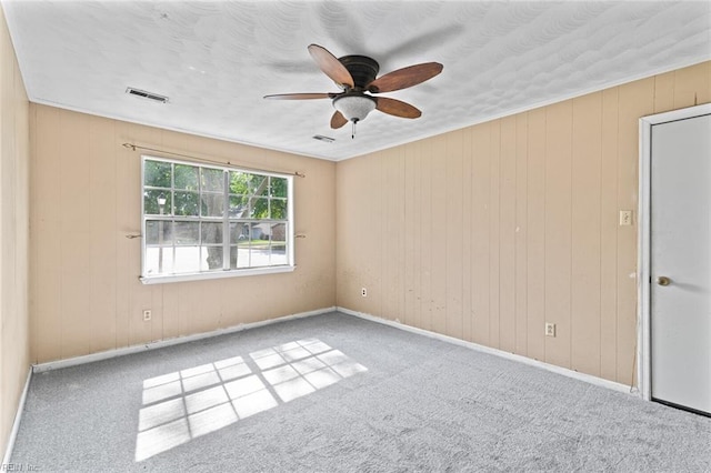 120 Commodore Dr, Hampton, VA 23669 - carpeted empty room with ceiling fan, wood walls, and baseboards