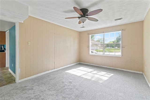 120 Commodore Dr, Hampton, VA 23669 - carpeted spare room featuring ceiling fan, a textured ceiling, baseboards, and wooden walls