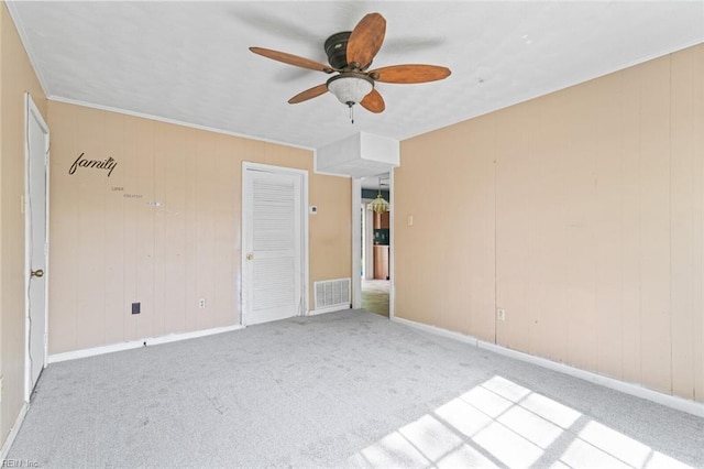 120 Commodore Dr, Hampton, VA 23669 - spare room with a ceiling fan, carpet, baseboards, and wood walls