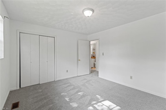 120 Commodore Dr, Hampton, VA 23669 - unfurnished bedroom featuring baseboards, carpet, a closet, and a textured ceiling