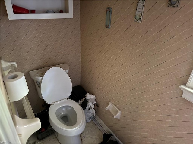 bathroom with toilet and tile patterned flooring