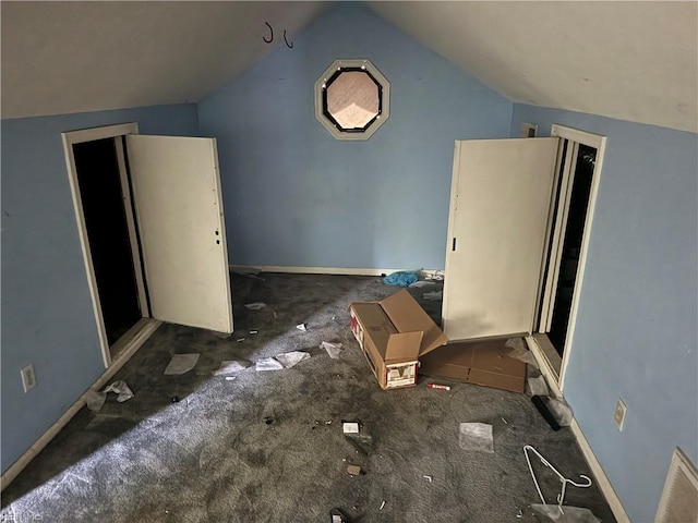 additional living space with vaulted ceiling and carpet flooring
