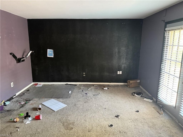 empty room with carpet, plenty of natural light, and baseboards