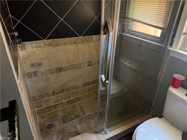 full bath featuring toilet and a stall shower