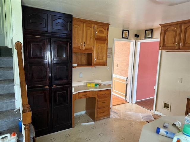 kitchen with light floors, light countertops, and brown cabinetry