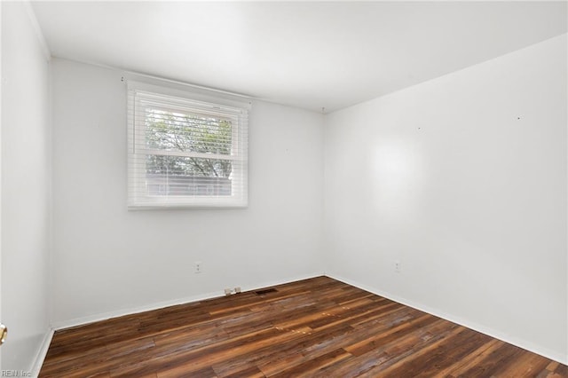 empty room with wood finished floors and baseboards