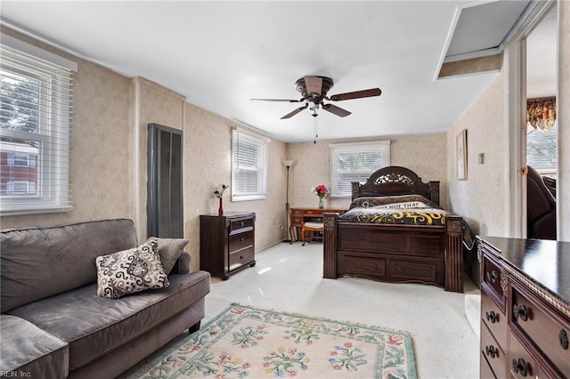 bedroom featuring light colored carpet and a ceiling fan