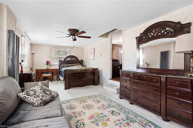 bedroom with light colored carpet and a ceiling fan
