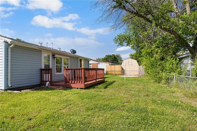 view of yard featuring a storage shed, a deck, and an outdoor structure