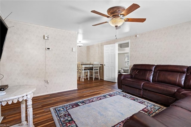 living room with wood finished floors, ceiling fan, baseboards, and wallpapered walls