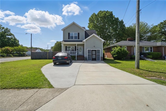 traditional-style house featuring concrete driveway, a front yard, covered porch, and fence