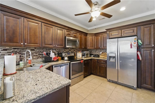 kitchen featuring a sink, stainless steel appliances, tasteful backsplash, a ceiling fan, and light tile patterned floors