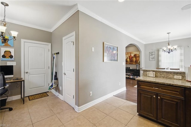 interior space with an inviting chandelier, light tile patterned floors, baseboards, and ornamental molding
