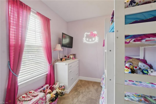 carpeted bedroom featuring baseboards