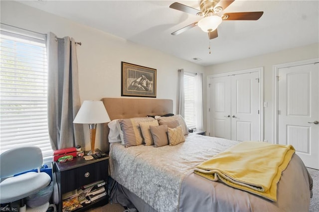 bedroom with a ceiling fan, a closet, and carpet floors