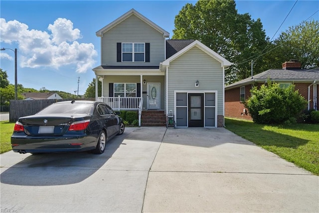 view of front of home featuring a porch, fence, and a front yard