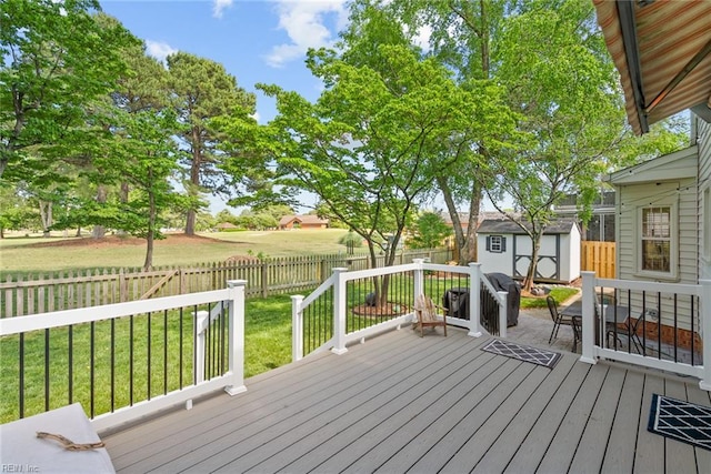 wooden deck featuring a shed and an outbuilding