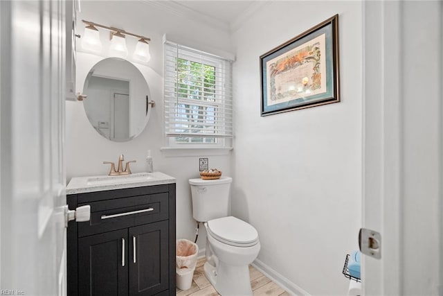 bathroom featuring toilet, crown molding, wood finished floors, vanity, and baseboards